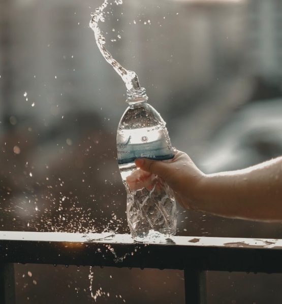 white and blue labeled disposable bottled water